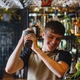 Team member making a cocktail behind the bar
