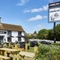 The exterior facade with signage and beer garden seating area of the Rovers Tye.