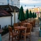The exterior facade and beer garden seating area of The White Hart, with wooden picnic tables and shade umbrellas.