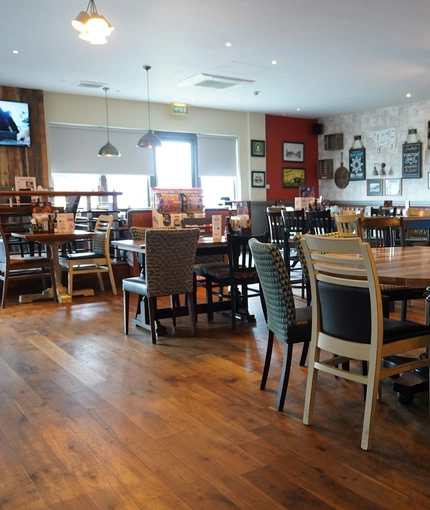 interior of the restaurant with seating area with TV's