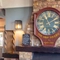 The brick fireplace and large clock inside The Ship in Mortlake.
