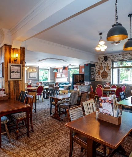 Interior dining area of a pub with a TV.