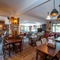 Interior dining area of a pub with a TV.