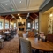 Interior dining area of a pub with a TV and a fireplace.