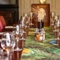 A close up image of the table decor featuring cutlery, glasses and peacock design table runner within one of the function rooms at The Vine.