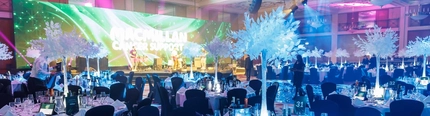 The interior seating area with event space and stage at the Macmillan gala.
