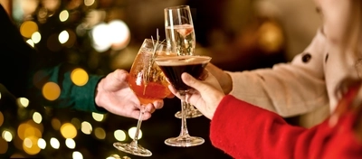 An image of 3 drinks being held during a festive cheers at a Chef & Brewer venue.