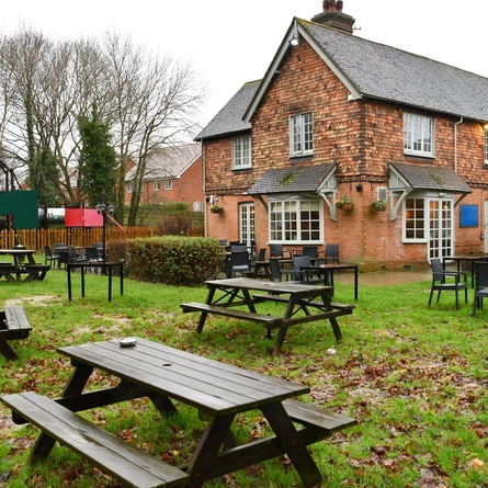 The exterior of the venue with beer garden seating area at Heathy Farm.