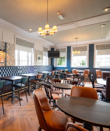 The interior restaurant and seating area with TV at the Black Horse.