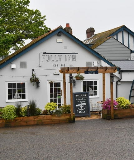 Exterior facade of a pub with a seating area.