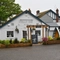 Exterior facade of a pub with a seating area.