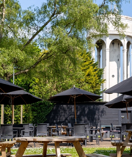 Exterior beer garden of a pub with a seating area.