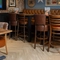 An interior restaurant seating area at the Cuckoo Oak, with an upholstered booth seat, and a TV on the wall.