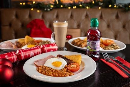 A kids breakfast on a table, next to some presents.