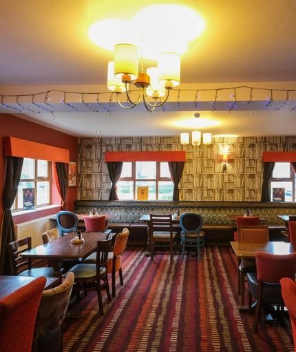 interior dining area of a pub with a TV