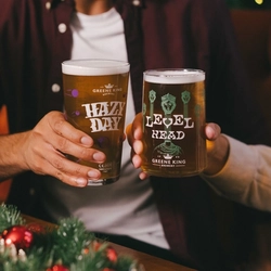 Two people holding drinks in a toast.  One is holding a pint of Hazy Day whilst the other has a pint of Level Head.
