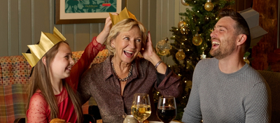 A banner showing a family sat at a table enjoying drinks and Christmas Day dishes at a Chef & Brewer venue.