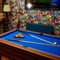 The interior games area at The Windmill Inn in York, with a pool table, a TV on the wall, and a brick fireplace.