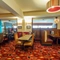 Interior dining area of a pub with a gambling machine.