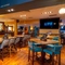 The bar and interior restaurant seating area at the Counting House, with TVs on the walls.