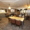 Interior dining area of a pub with a fireplace.