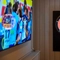 A close up view of the illuminated dartboard at the Devonshire Arms, and the large TV on the wall adjacent to it.