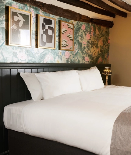 A bed in a hotel room of The Narborough Arms.