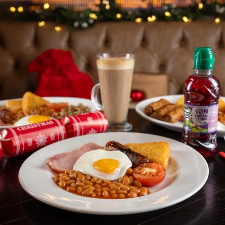 A kids breakfast on a table, next to some presents.
