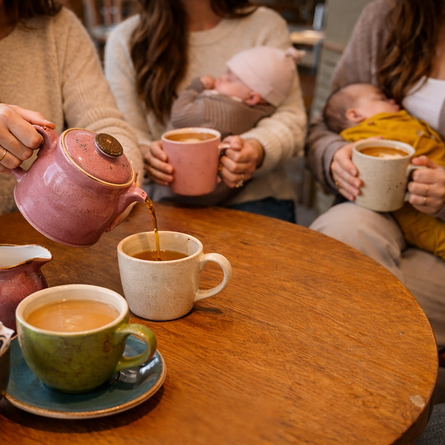 An image of a group of ladies holding babies sat at a table having hot drinks to advertise a Local Mama Brunch What's On event at The Boat.