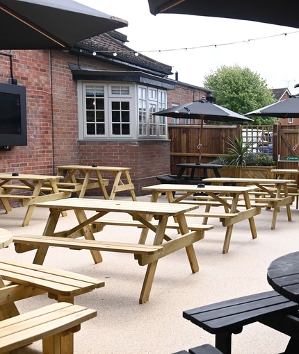 The exterior beer garden seating area with outdoor TV at The Greengage.