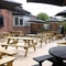 The exterior beer garden seating area with outdoor TV at The Greengage.