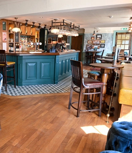 The interior bar and restaurant seating area with electronic pub game at The Yorkshire Grey.
