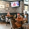 Interior dining area of a pub with a TV.