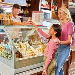 mum and child being served ice cream by staff member at ice cream counter