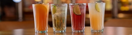 A selection of mocktails on a wooden table of a pub