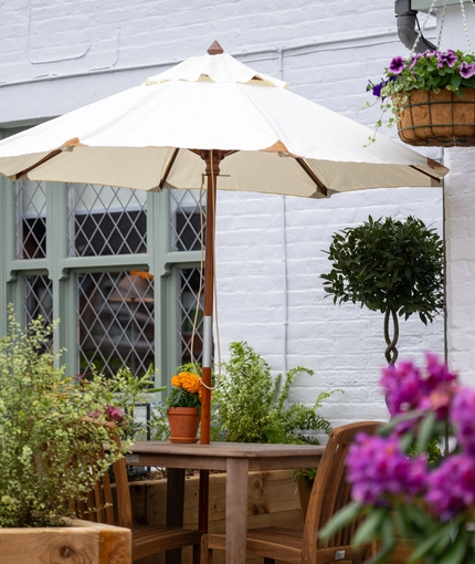 A table with an umbrella in the beer garden of the Grapes.