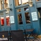 The exterior facade, signage, and seating area at the Rhoderick Dhu in Glasgow; with large golden lanterns hanging on the wall.