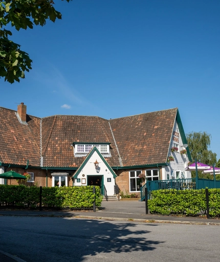 A view from across the road of the exterior facade, signage, and entrance of the Rudds Arms in Marton-In-Cleveland.