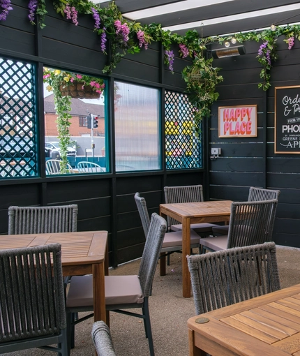 The exterior sheltered beer garden and seating area at the Tudor Arms.