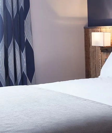 The interior of one of the hotel rooms featuring a double bed at The Churchill.