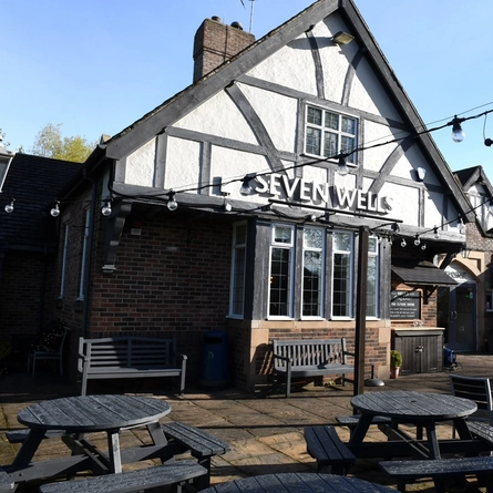 Exterior facade of a pub with a seating area.