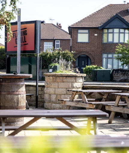 Exterior beer garden of a pub with a seating area.