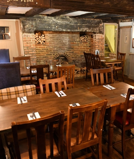 interior dining area of a pub with a fireplace
