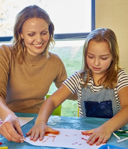 A mother and daughter painting together
