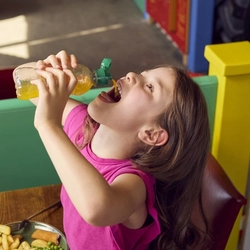 A girl drinking a fruit shoot