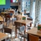 The interior restaurant and seating area with TV at the Woodlands Edge.