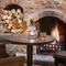 small circle table positioned in front of open fireplace with 2 large cushioned armchairs