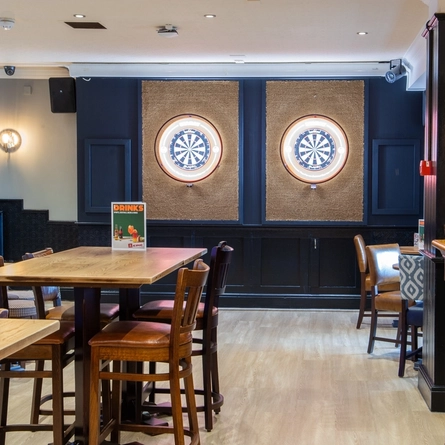 The interior restaurant, seating and games area with dart boards area at the Poachers.
