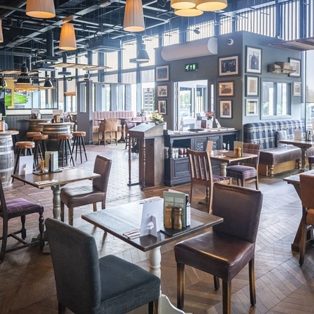 The interior restaurant seating area with electronic pub games at The Isle Of Ely.