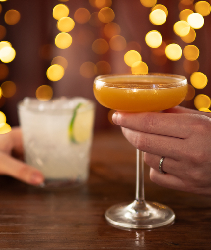 a man and a woman holding cocktails